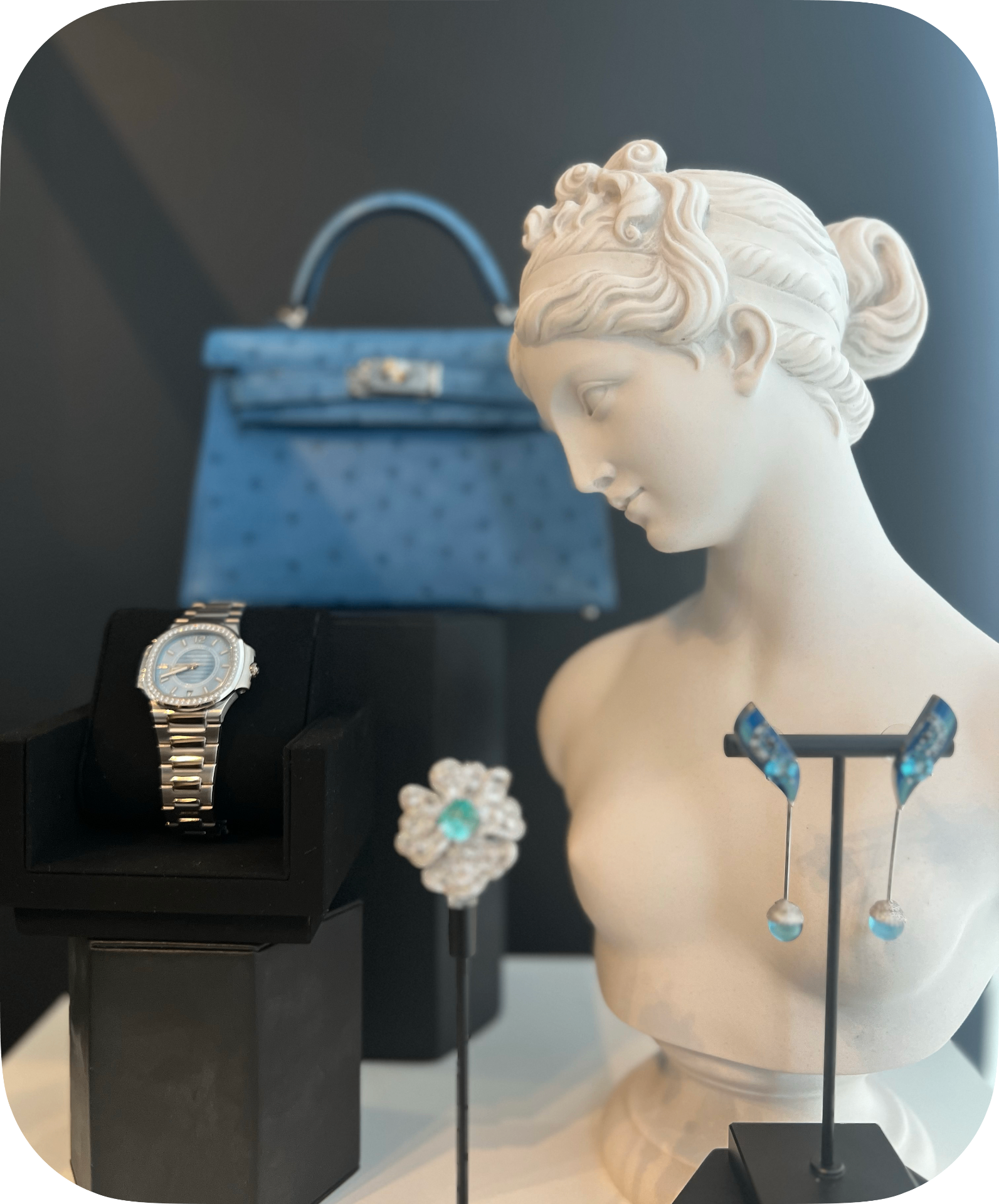 Brown satin gloves showcasing Patek Philippe watches and bracelets on burgundy Hermes Kelly